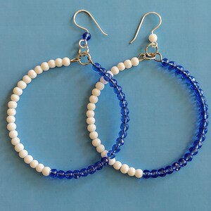 Handmade blue and white hoop earrings.