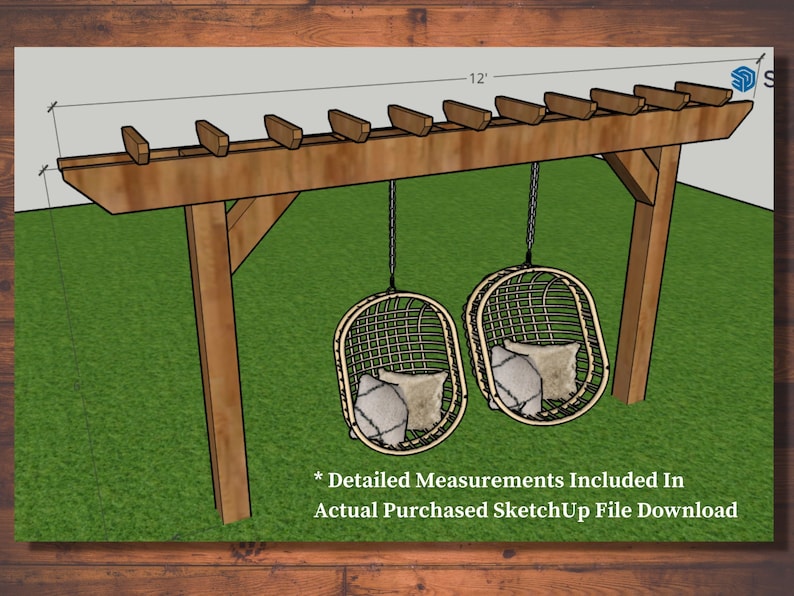 May include: A wooden pergola with two hanging wicker chairs, each with a pillow. The pergola is 12 feet wide and has a brown finish. The chairs are suspended by chains and sit on a green lawn. Text: Detailed Measurements Included In Actual Purchased SketchUp File Download.