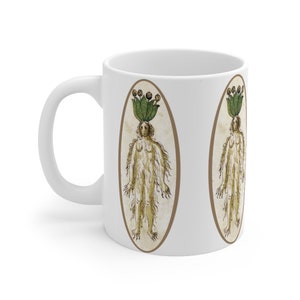 May include: White ceramic mug with a print of a vintage illustration of a woman with a plant growing from her head. The illustration is in an oval frame and is repeated twice on the mug.