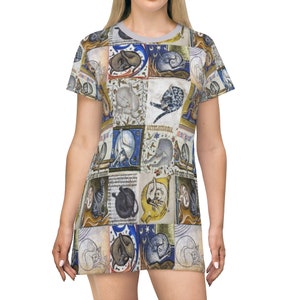 May include: A gray t-shirt dress with a pattern of medieval illustrations of cats in various poses. The cats are depicted in shades of blue, brown, and white.