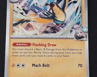 May include: A Stage 1 Iono's Kilowattrel trading card with 120 HP. The card features a bird-like creature with yellow and black wings, the Flashing Draw ability, and a Mach Bolt attack of 70. It includes a small illustration of the character Iono.