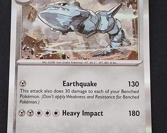 May include: A Steelix trading card with 180 HP, featuring a metallic, segmented snake-like creature in a rocky landscape. The card displays the Earthquake and Heavy Impact attacks, with text detailing its evolution from Onix and physical stats.