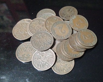May include: A collection of 19th century German coins, featuring the German eagle and the text "Deutsches Reich" and "Ein Pfennig". The coins are made of copper and have a brown patina.