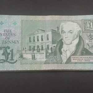 May include: A one pound banknote from the States of Guernsey, featuring a portrait of Daniel de Lisle Brock, Bailiff of Guernsey from 1762 to 1842. The note also depicts the Royal Court building in St. Peter Port.