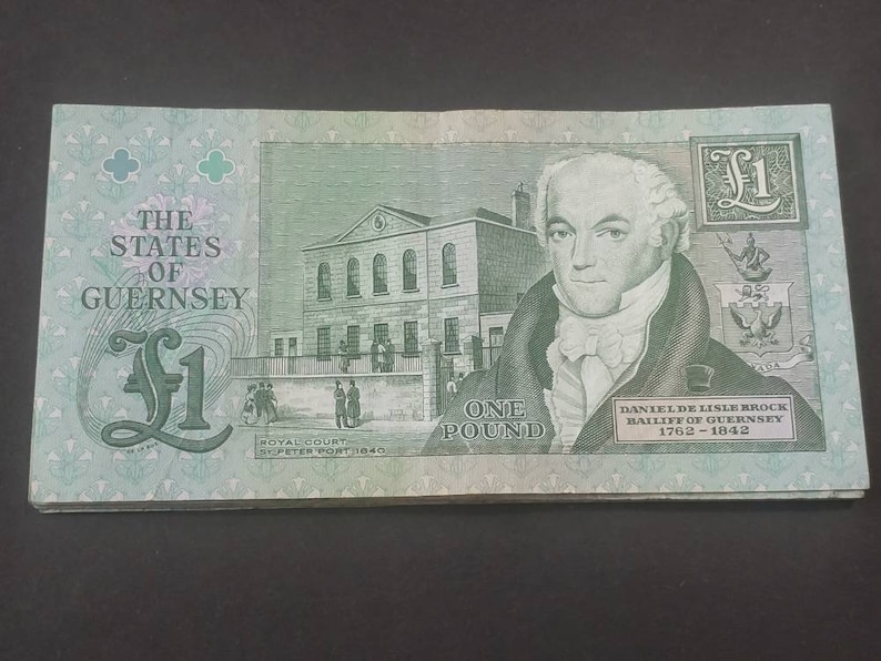May include: A one pound banknote from the States of Guernsey, featuring a portrait of Daniel de Lisle Brock, Bailiff of Guernsey from 1762 to 1842. The note also depicts the Royal Court building in St. Peter Port.