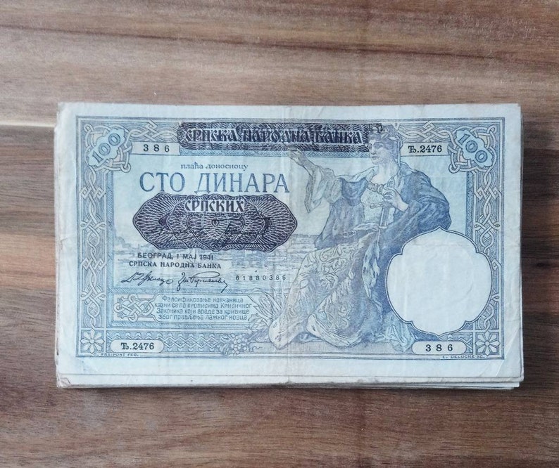 May include: A vintage 100 Serbian dinar banknote featuring a portrait of a woman in a long robe. The note is dated 1 May 1941 and bears the text "Srpska Narodna Banka" (Serbian National Bank).