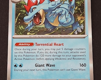 May include: A Feraligatr trading card with 180 HP, featuring a blue creature with red spikes in a forest setting. The card displays the Torrential Heart ability and Giant Wave attack, with text detailing its stats, evolution, and game mechanics.