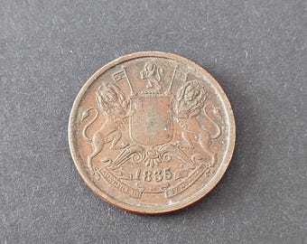 May include: A round copper-colored coin featuring an embossed coat of arms with two lions flanking a central shield. Above the shield is a small lion figure, and below the shield is the year 1835 with text inscribed along the bottom edge.