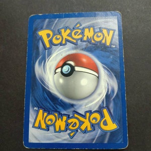 May include: A blue and white Pokemon trading card with the Pokemon logo and a Pokeball graphic on the back.
