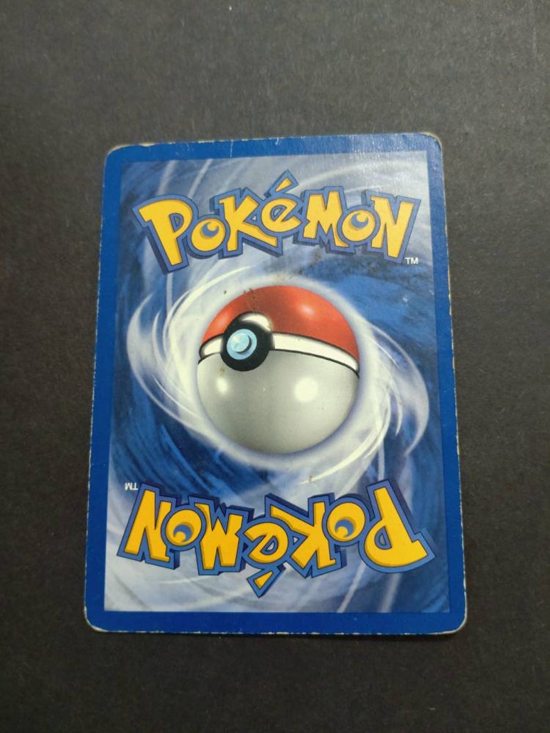May include: A blue and white Pokemon trading card with the Pokemon logo and a Pokeball graphic on the back.
