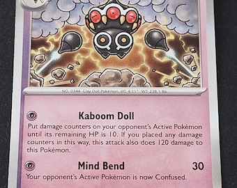 May include: A purple Claydol trading card featuring the character with red eyes and black appendages floating above rocks. The card displays 120 HP, the attacks Kaboom Doll and Mind Bend, and text detailing the character's height of 4'11" and weight of 238.1 lbs.