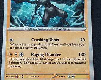 May include: A Zekrom trading card featuring the Deep Black Pokémon with 130 HP. The card displays the Crushing Short and Raging Thunder attacks, with lightning energy symbols, a weakness to fighting types, and a retreat cost of two colorless energy.