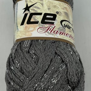 May include: A skein of gray yarn with silver metallic thread. The yarn is labeled "Ice Yarn Flamenco".