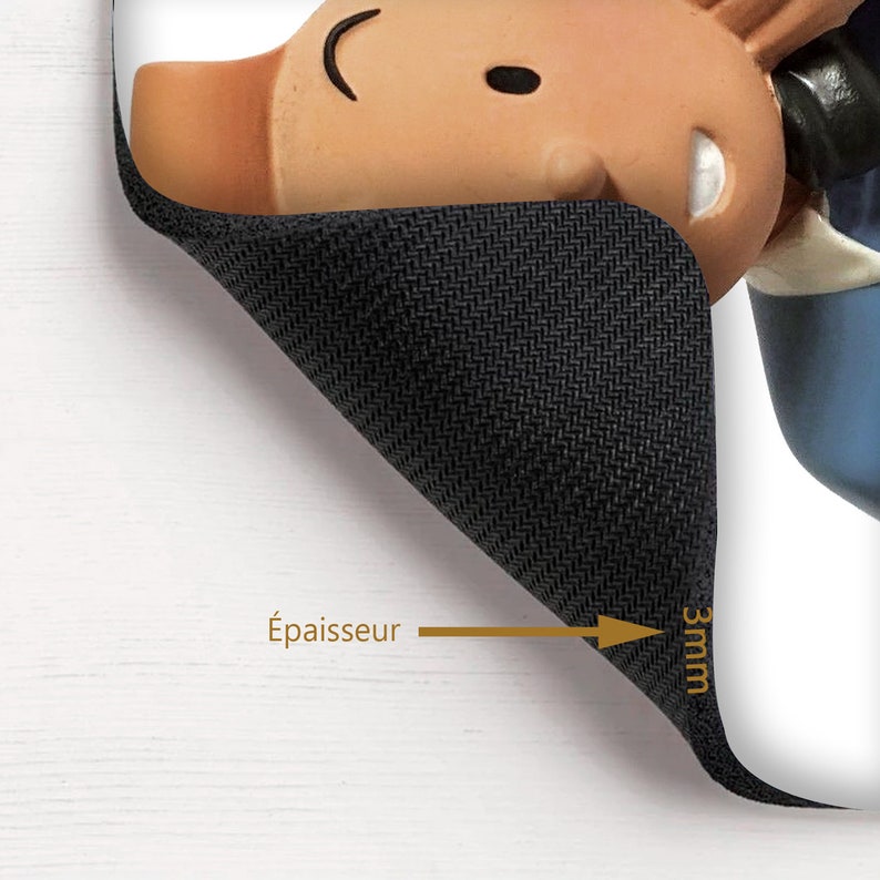 May include: A black mouse pad with a cartoon character design. The mouse pad is 3mm thick and has a textured surface.