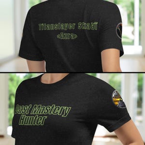 May include: Black t-shirt with a green graphic that says "Beast Mastery Hunter" and a yellow patch with a black and white graphic on the right sleeve.