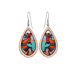 May include: A pair of teardrop-shaped earrings with a copper finish. Each earring features a colorful image of a Native American Kokopelli flute player with a turquoise background.