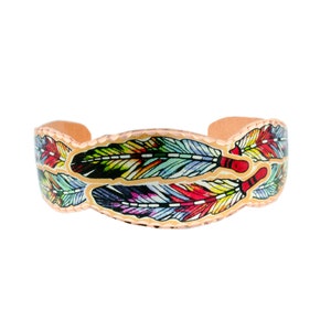 May include: A copper bracelet with a colorful feather design. The feathers are painted in shades of blue, green, red, yellow, and purple.