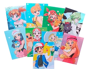 May include: A selection of glossy art prints showcasing characters from the Pokémon franchise. Each print features a different character in vibrant colours and detailed illustrations, ideal for fans of the series.