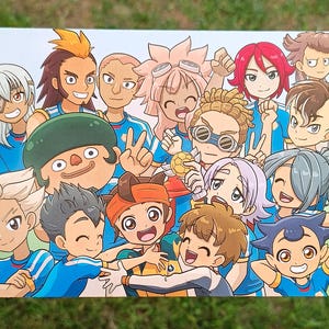 May include: A group of 13 cartoon characters, mostly boys, wearing blue and white soccer uniforms. They are all smiling and some are holding a soccer ball. The characters are drawn in a colorful anime style.