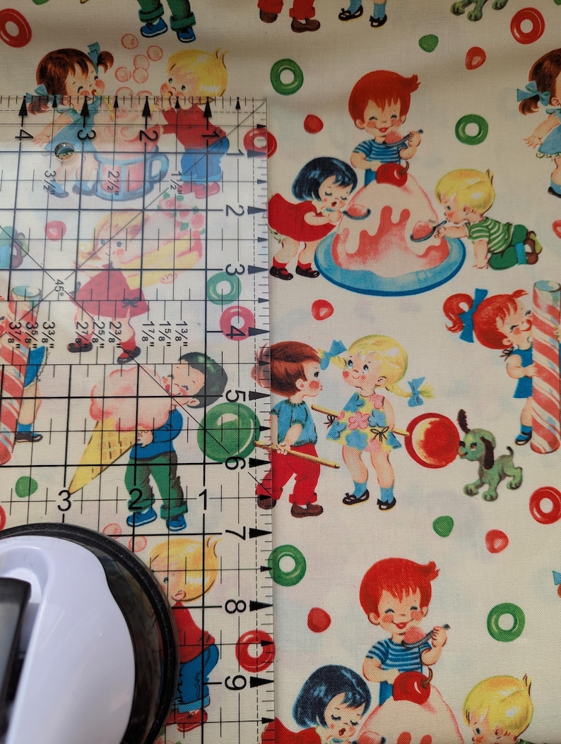 May include: Fabric with a repeating pattern of vintage-style children, ice cream, and candy. The children are depicted in various poses, with red, blue, and yellow clothing. The background is a cream color with red and green circles.