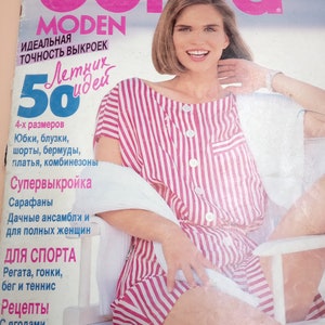 May include: A June 1991 issue of Burda Moden magazine featuring a cover with the text 'burda MODEN' and '50'. The cover displays a person wearing a red and white vertically striped short-sleeved garment with white buttons, sitting on a white chair.