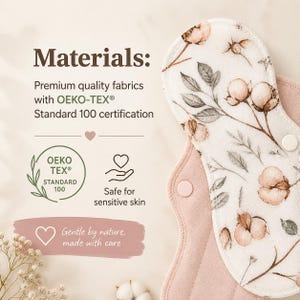 May include: A reusable cloth menstrual pad with a white top layer featuring a brown cotton plant print and a solid dusty pink underside. The text reads Materials: Premium quality fabrics with OEKO-TEX Standard 100 certification, Safe for sensitive skin, and Gentle by nature, made with care.