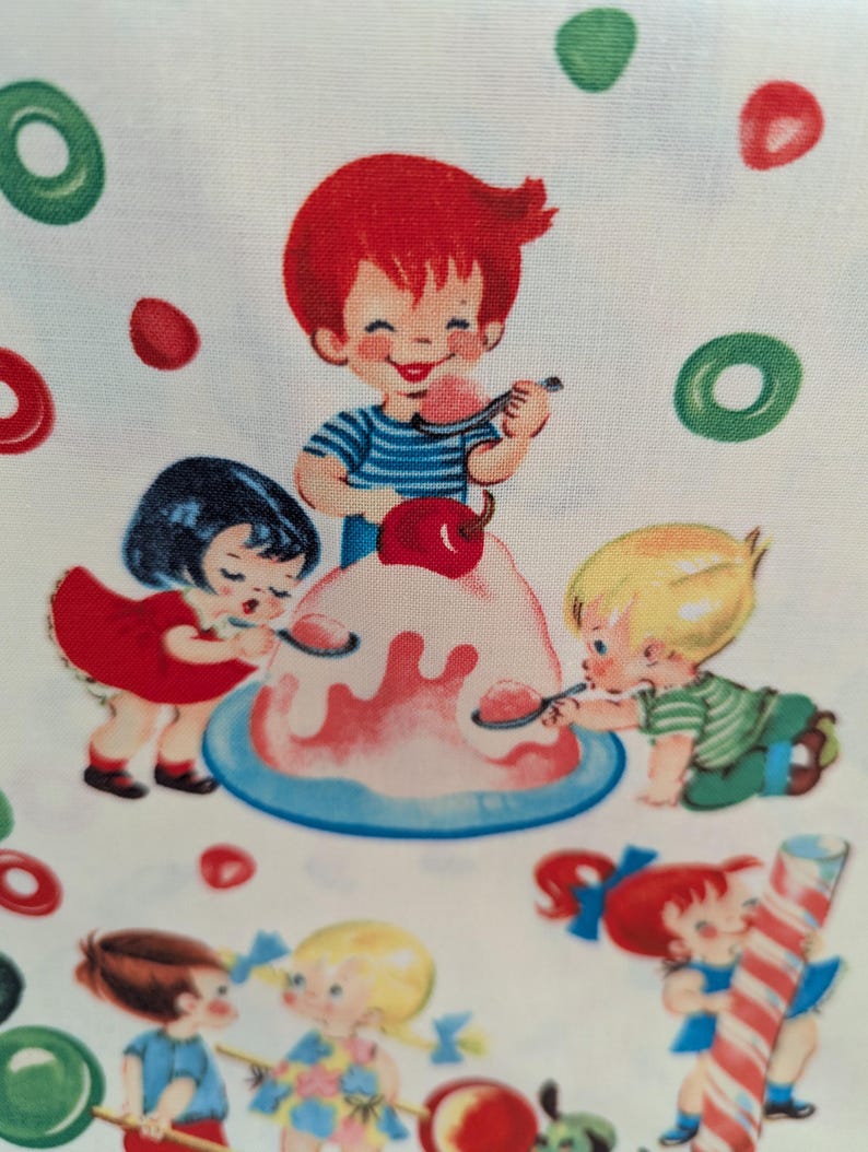 May include: A fabric print featuring a vintage illustration of children enjoying a dessert. The image shows a boy with red hair and a blue striped shirt eating from a pink dessert. Other children are also eating the dessert. Green and red candies are scattered around the image.