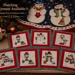 May include: A collection of Christmas-themed placemats featuring snowman designs. Each square placemat has a red border and a gray backing. The snowmen are depicted with various accessories and poses, set against a snowy backdrop. The text "Matching Placemats Available" is visible.