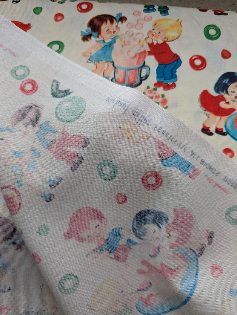 May include: Two pieces of fabric with a vintage children's print. One fabric features a repeating pattern of children playing with a large drink, and the other fabric has a pattern of children with balloons and circles in red, green, and blue. The fabric is off-white.