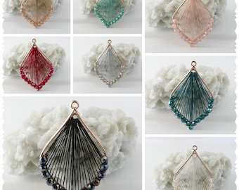 May include: Assortment of six beaded and wire pendant charms in various colors, including black, white, red, teal, and pink. Each charm features a diamond-shaped design with a wire frame and beaded fringe.