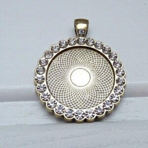 May include: Gold-toned pendant with a clear glass insert surrounded by clear rhinestones.
