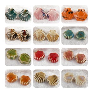 May include: Assortment of 10 pairs of ceramic seashell beads in various colors and patterns, including green, blue, brown, pink, orange, and red.