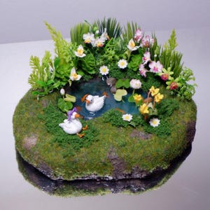 Miniature fish pond with little cute ducks and flowers , fairypond , duck pond