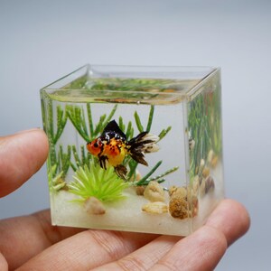 Miniature clay goldfish in the tank