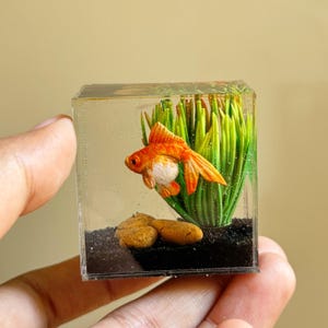 Miniature clay goldfish in the tank
