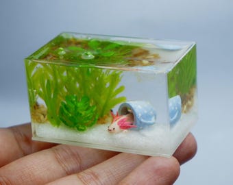 Miniature clay axolotl with little cup in the tank