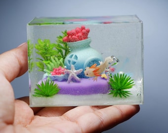 Miniature clay axolotl with little house in the tank