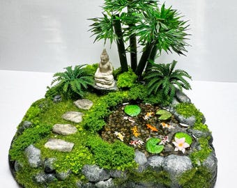 Miniature zen garden and koi pond decorated with buddha statue