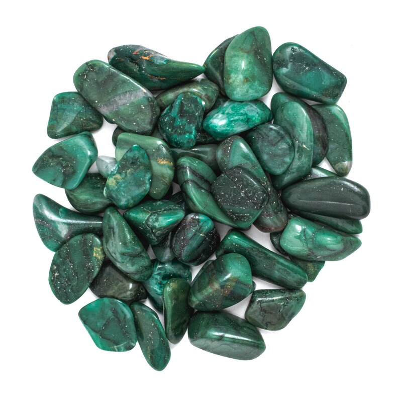 May include: A collection of green tumbled stones, likely aventurine, arranged in a heart shape. The stones are smooth and polished, with a variety of shades of green.