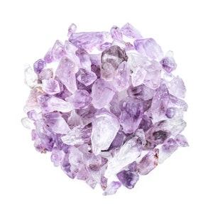 May include: A large pile of amethyst crystals in various sizes and shapes. The crystals are a light purple color and have a natural, rough texture.