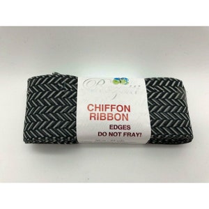 May include: A roll of black and white chevron patterned chiffon ribbon. The label reads "Chiffon Ribbon" and "Edges Do Not Fray!" with a measurement of 30 m - 33 yds.