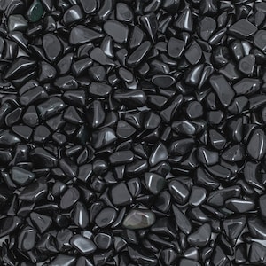 May include: A close-up image of a large quantity of black tumbled stones. The stones are smooth and polished, with a glossy finish.