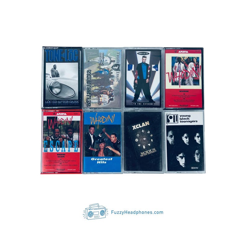 May include: A collection of vintage cassette tapes featuring album art with various artists and titles. The tapes are in different colors, including red, blue, and black. The image includes the text "FuzzyHeadphones.com".