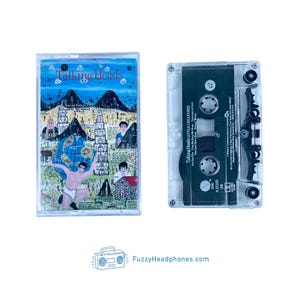 May include: A vintage cassette tape of Talking Heads' album "Little Creatures". The cassette tape is in a clear plastic case with a black label. The label features the album title, band name, and a small image of a globe.