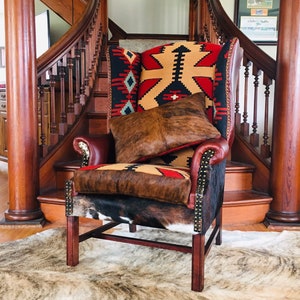 SOLD-Reupholstered wingback chair with Turkish kilim rug, leather and cowhide. Made to order****