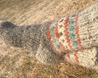May include: A pair of gray and white wool socks with a colorful geometric pattern. The socks are knitted and have a fuzzy texture.