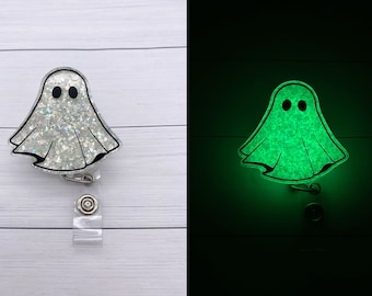 May include: A white glitter ghost with black eyes on a clear retractable badge reel. The ghost glows green in the dark.