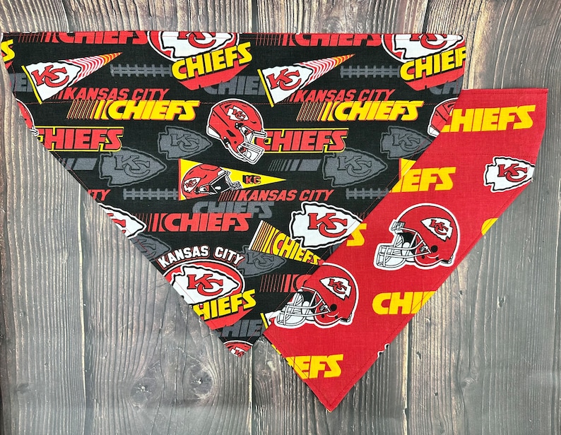 May include: Two dog bandanas, one black with white and yellow Kansas City Chiefs logos and the other red with yellow Kansas City Chiefs logos.