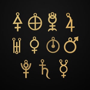 May include: Gold-colored pendants featuring various astrological and alchemical symbols. The pendants are displayed against a black background. Each pendant has a small loop at the top for hanging.