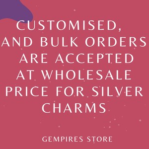 May include: A pink background with white text that reads: "CUSTOMISED, AND BULK ORDERS ARE ACCEPTED AT WHOLESALE PRICE FOR SILVER CHARMS." The text is in a sans-serif font. The words "GEMPIRES STORE" are at the bottom.
